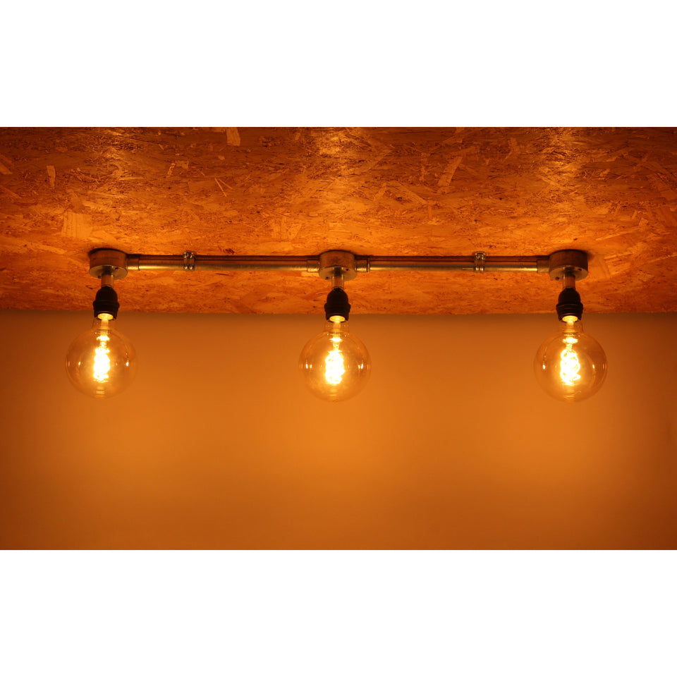 E27 conduit light fitting with globe bulbs lit