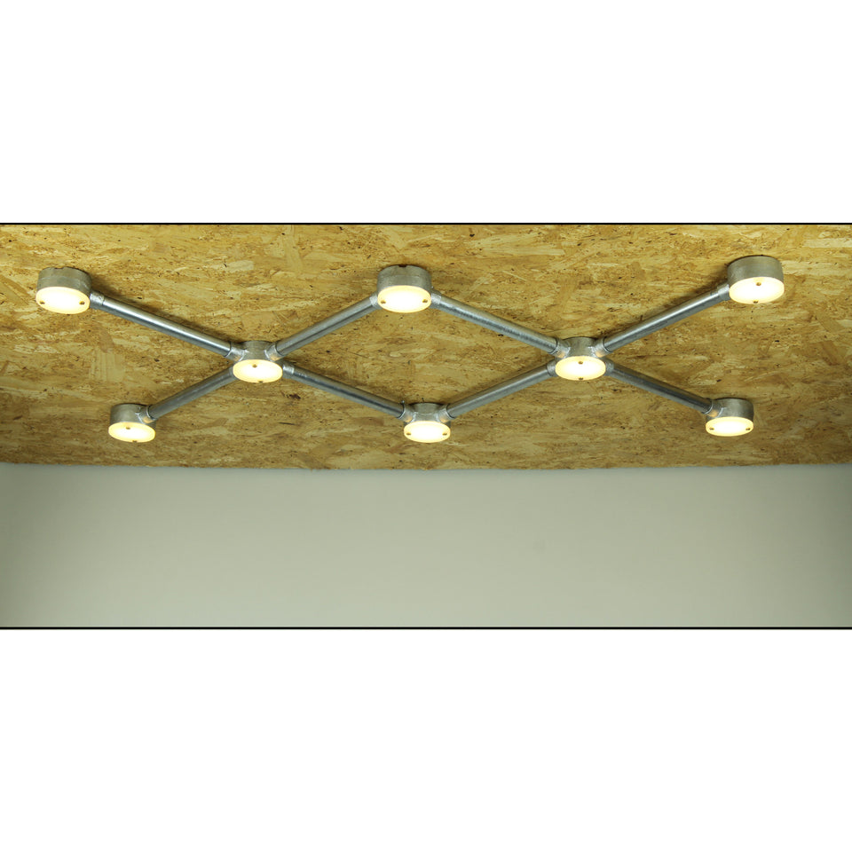 Conduit light fixture with lit dots side on 