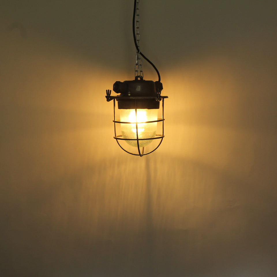 Industrial Salvage Pendant light fitting with glass dome and wire cage - lit